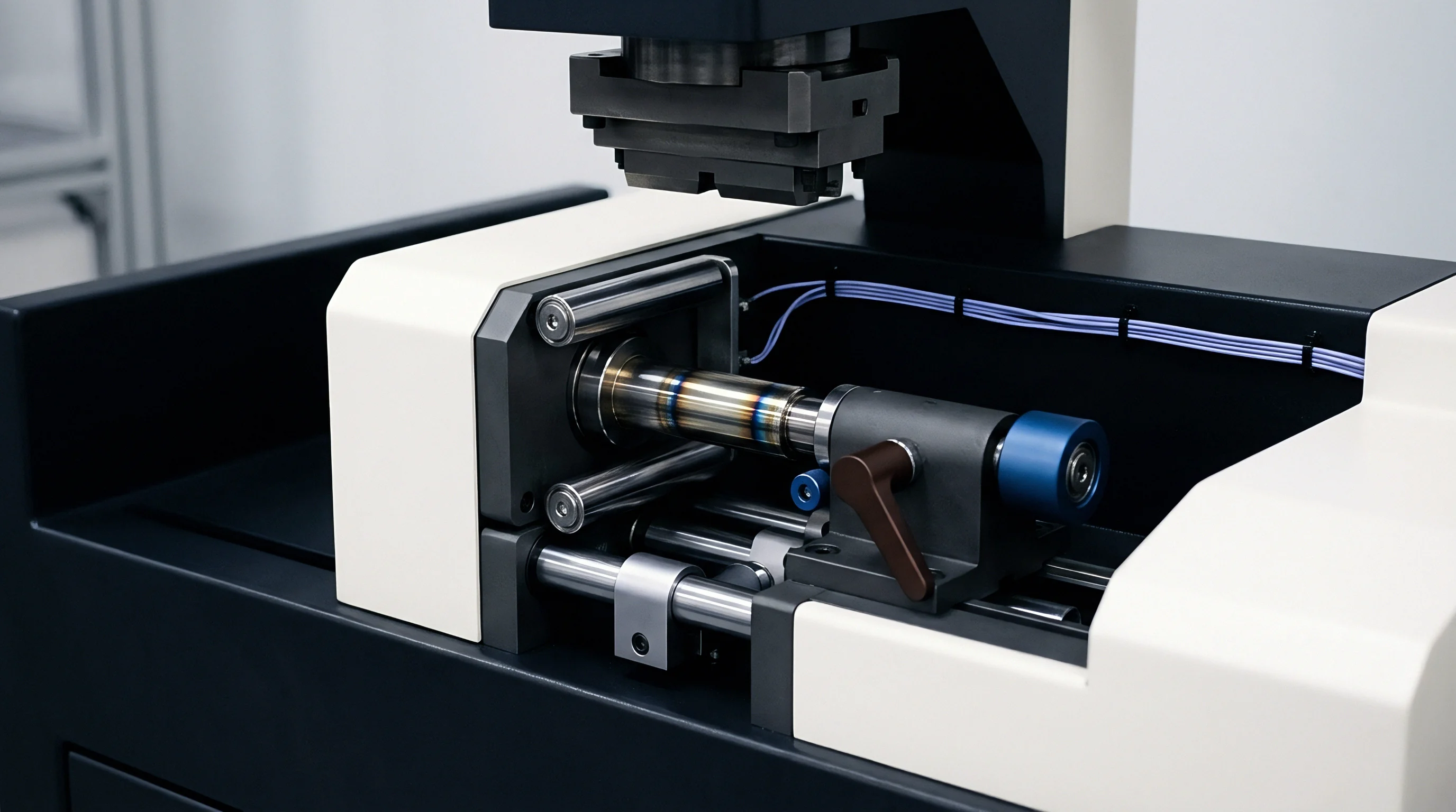 Industrial mechanical testing equipment securely clamps a welded cylindrical metal component between parallel guide rails inside a factory production cell.